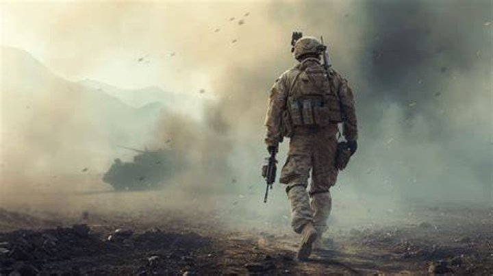 A Battlefield operator walks away from the camera holding a gun.