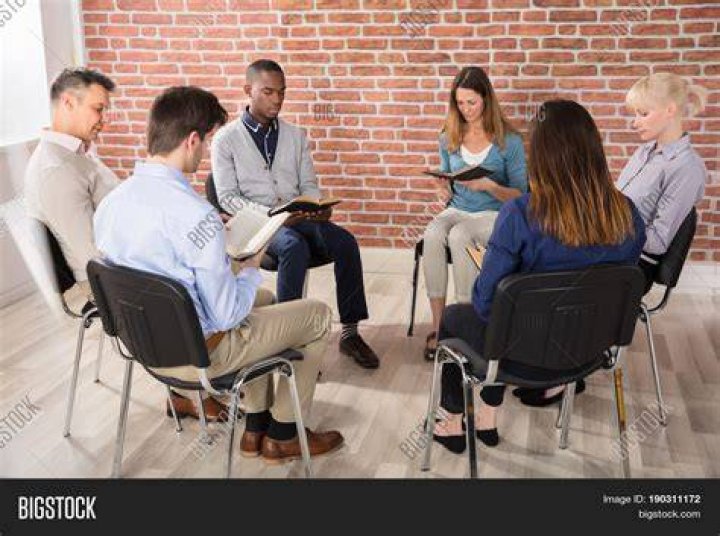 a group of people sitting in chairs