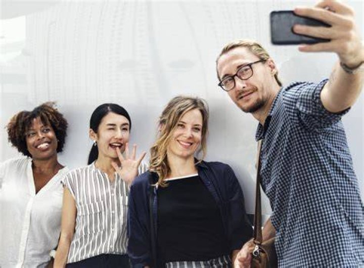 a group of people taking a selfie