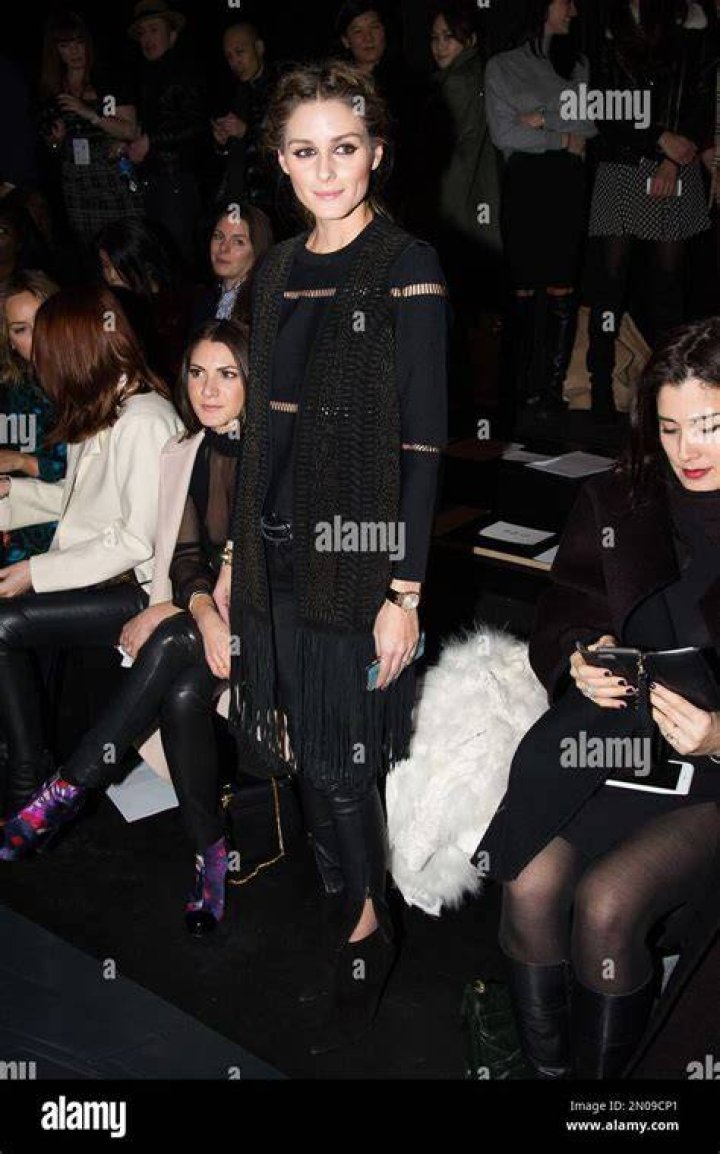 <p>Olivia Palermo attends the Marchesa Spring 2012 show wearing a black ruffle evening dress, matching court shoes and grey clutch bag, September 2011.</p>